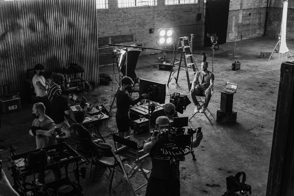 Film crew working on a set in a warehouse studio